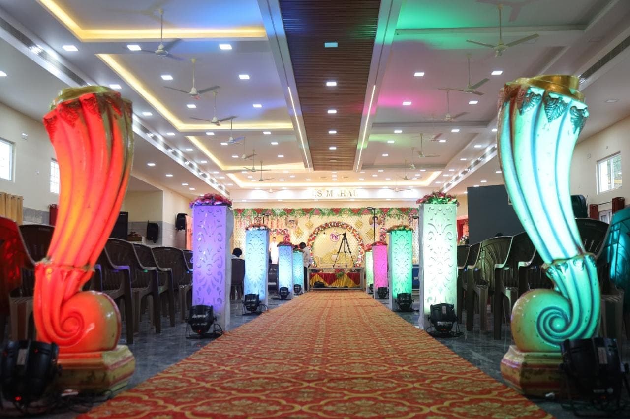 Glowing pillars lining the aisle of the AC banquet hall at S.S Mahal