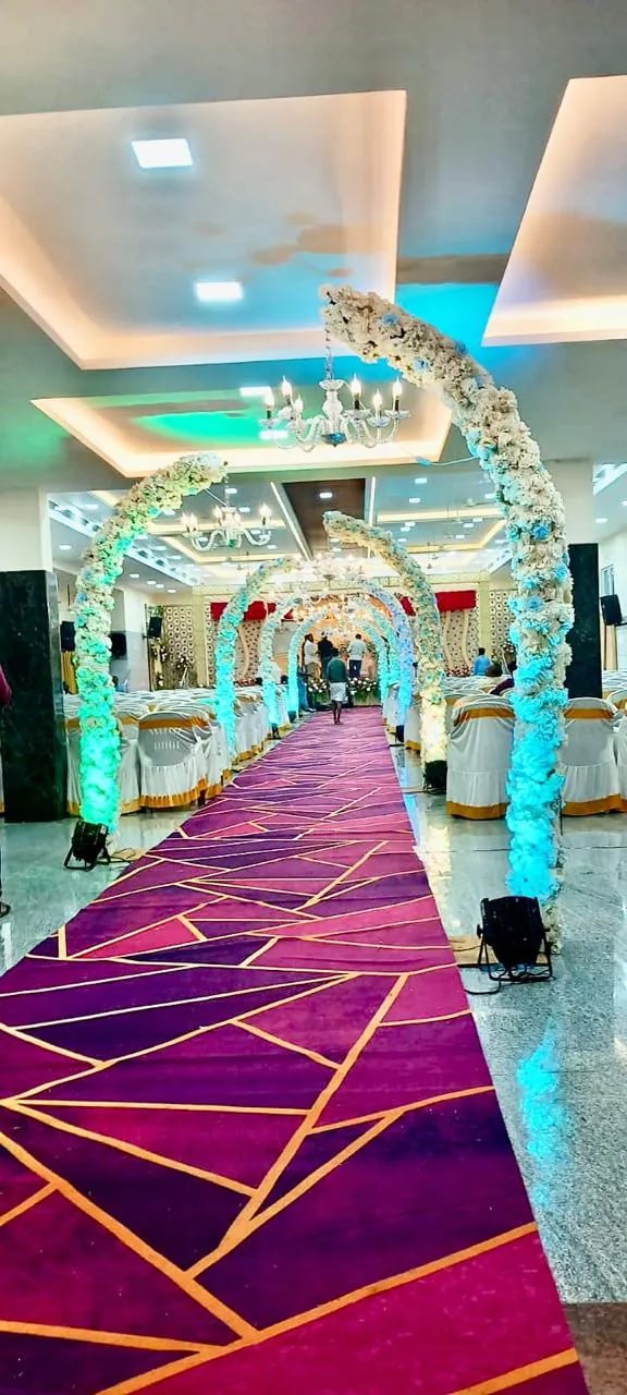 Floral arches over the walkway into the hall
